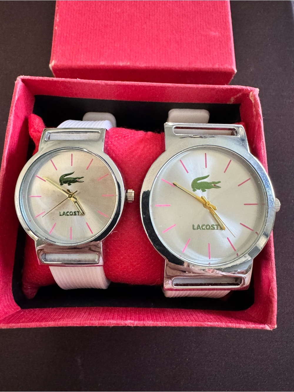 “Lacoste” His & Hers Silver Dial Watches with Pink Accents and Green Logo